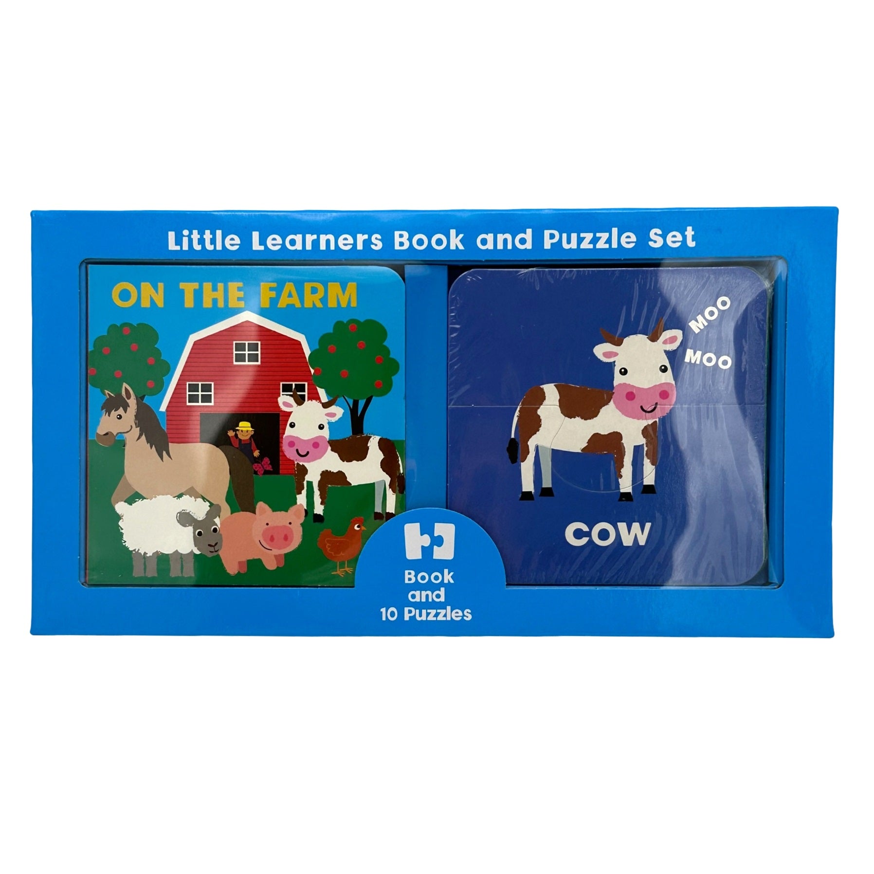Boxed "Little Learners Book and Puzzle Set" with a farm theme. The book cover features a barn, farm animals, and the text "On The Farm." Beside it are puzzle pieces wrapped in plastic, displaying a cow, the word "Cow," and "Moo" sound effects. The box is blue.